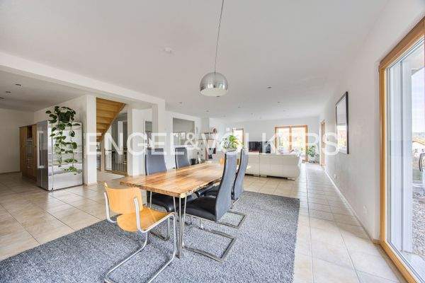 Lichtdurchfluteter Ess- und Wohnbereich mit wärmenden Kamin