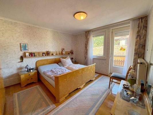 Schlafzimmer mit Balkonzugang im Obergeschoss