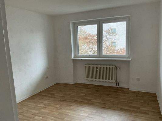 Schlafzimmer mit Doppelfenster und Fußboden in Holzoptik