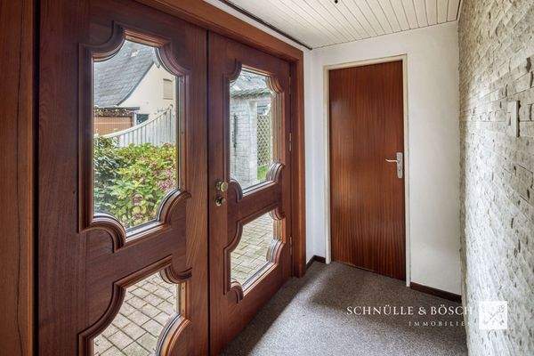 Nebeneingangstür mit Tischlerkunst und geschliffenem Glas 