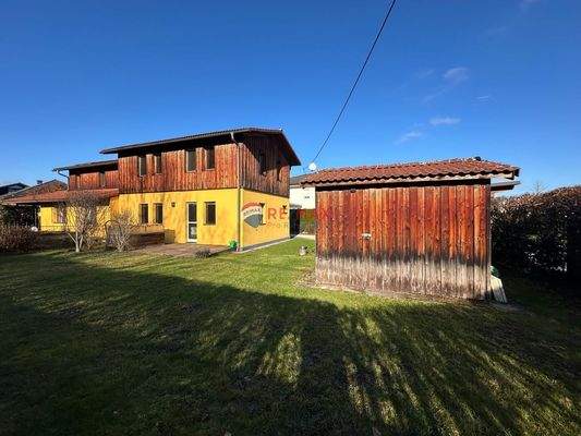 Gartenansicht mit Haus und Holzhütte