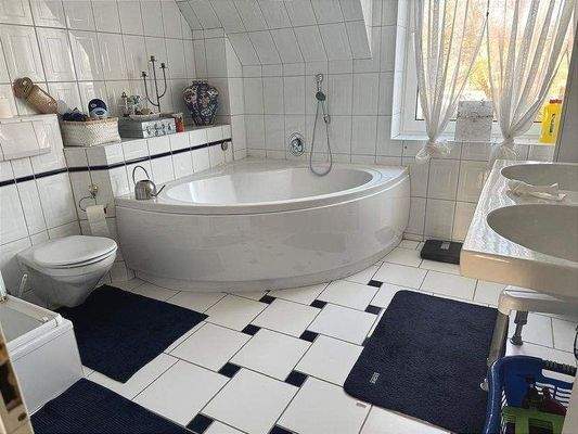 Ein helles Bad mit Badwanne, separater Dusche , Doppelwaschbacken und Vollausstattung im 1. Obergeschoss neben den beiden Schlafzimmern. 