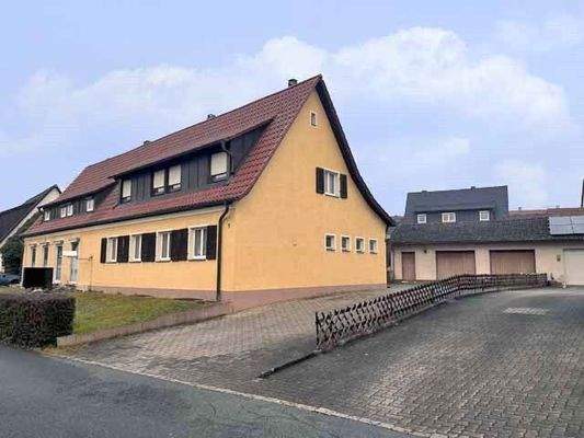 Außenansicht mit Zufahrt und Garagen