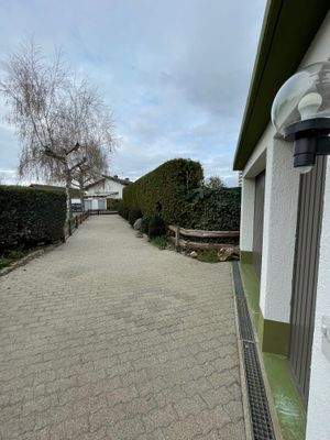 Lange Einfahrt zur großen Garage mit Eingang 