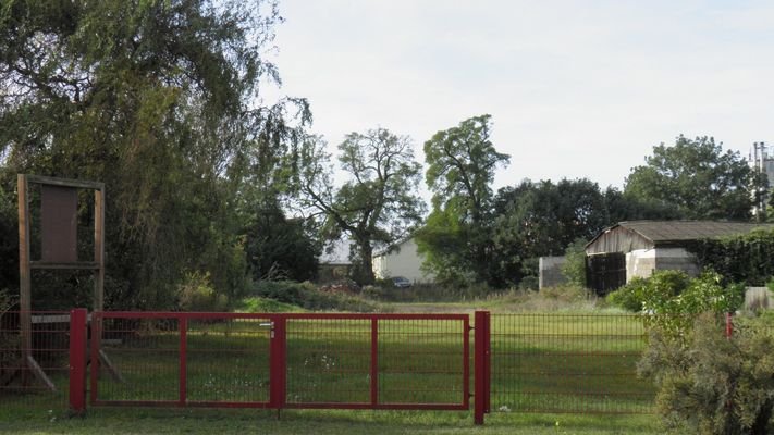 Straßenanschlussbereich mit Zaun u. Zufahrtstor 