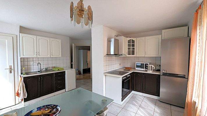 große Küche mit Einbauküche und Essbereich