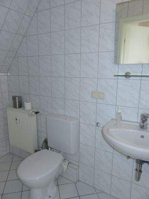 Hell gefliestes Bad mit Dusche