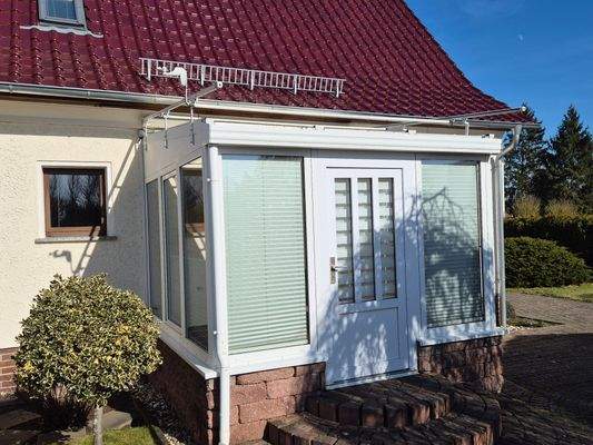 Hauseingang mit Wintergarten