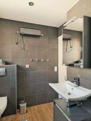 modernes Bad mit dunklen Fliesen