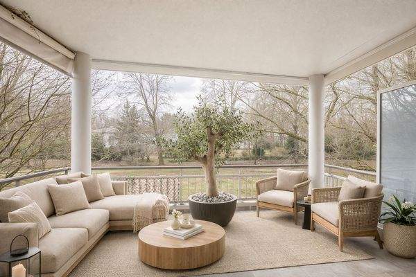 Überdachter Balkon mit Säulenarchitektur und Grünblick