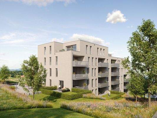 Modernes Mehrfamilienhaus mit hellbeiger Fassade und Balkonen, umgeben von gepflegten Rasenflächen und blühenden Wiesen unter blauem Himmel.