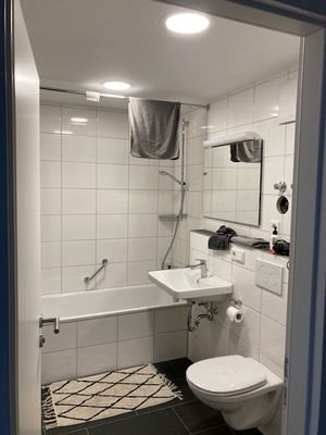 Badezimmer mit Wanne und Waschmaschinenanschluss