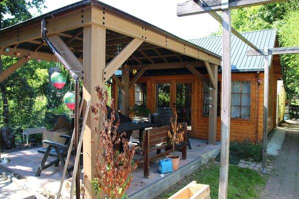 Holzhütte mit überdachter Sitzecke