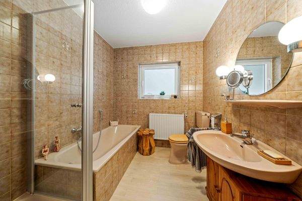 Badezimmer mit Badewanne und Dusche