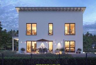 Dieses massa haus Fertighaus Einfamilienhaus im Lifestyle-Design präsentiert sich bei Dämmerung mit