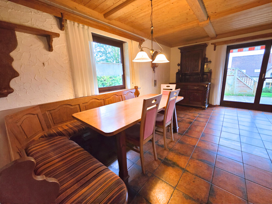 Esszimmer mit Sitzecke und Zugang auf die Terasse.png