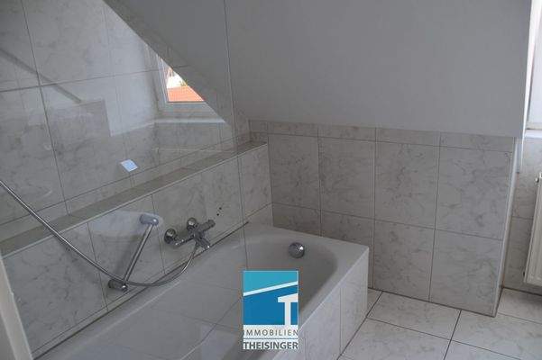 Badezimmer mit Wanne und Duschaufsatz