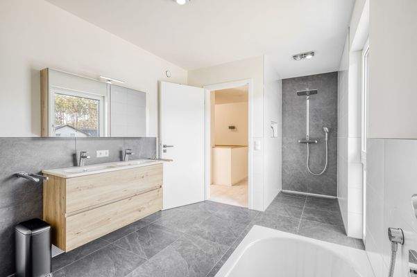 Modernes Badezimmer mit bodengleicher Dusche und hochwertiger Ausstattung