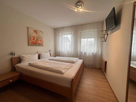 Helles Schlafzimmer mit durchdachter Raumaufteilung und fest verbauten Extras