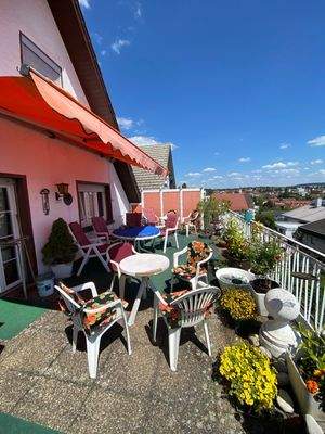 Terrasse mit Tischen und Stühlen nach Osten