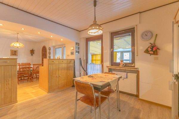 Esszimmer mit offener Küche und Zugang zum überdachten Außenbereich