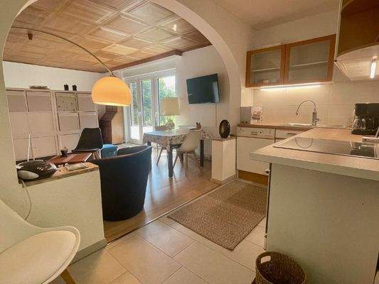 Wohnzimmer mit offener Küche und Gartenzugang im Erdgeschoss