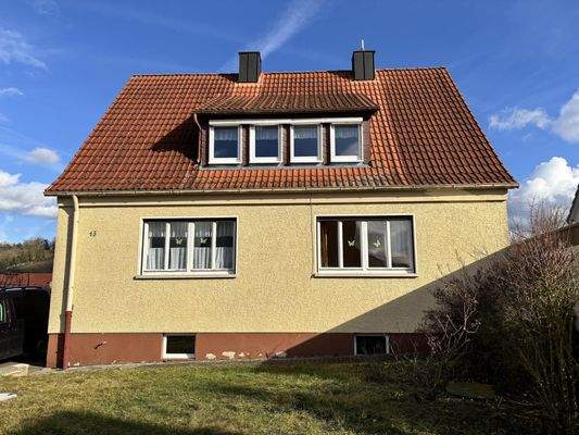 Westansicht mit großer Dachgaube und Vorgarten