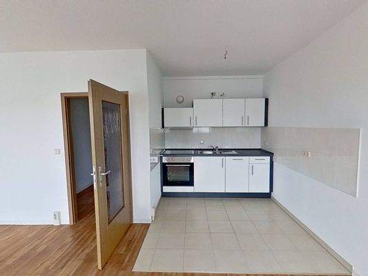 Ansicht IV: Wohn- und Esszimmer mit offenem Küchenbereich