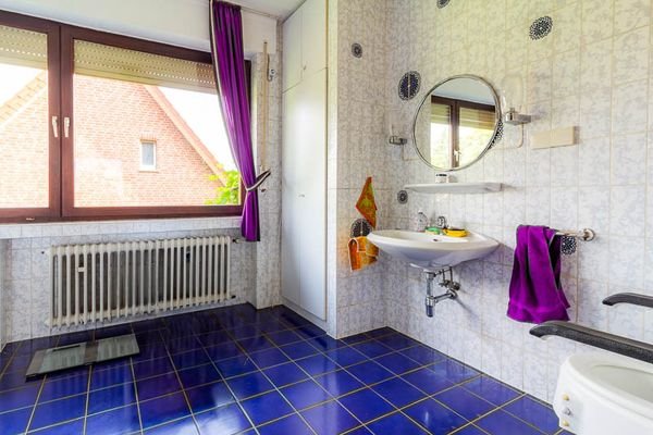 Das große Badezimmer im Obergeschoss beeindruckt mit einer Wanne und maßgefertigten Schränken – ein Ort der Entspannung und Organisation zugleich