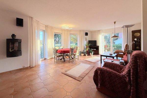 großes Wohn- und Esszimmer mit Erker, bodentiefen Fenstern und Kamin