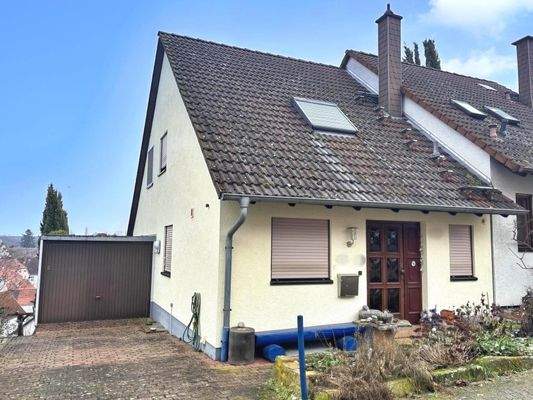 Hausfront mit Garage + Stellplatz