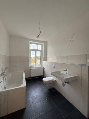 Badezimmer mit Badewanne und Dusche