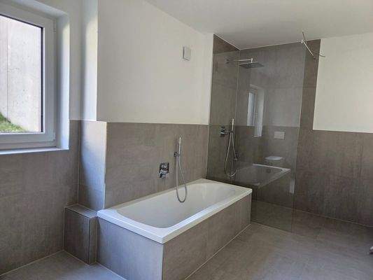 Badezimmer mit Badewanne und Dusche