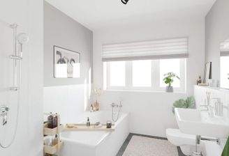 Ein modern gefliestes Badezimmer, inklusive Badewa