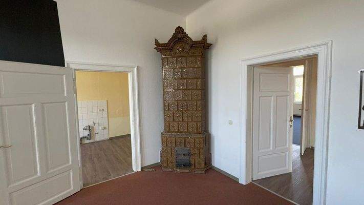 Durchgangszimmer mit großen Balkon und brunkvollen Ofen