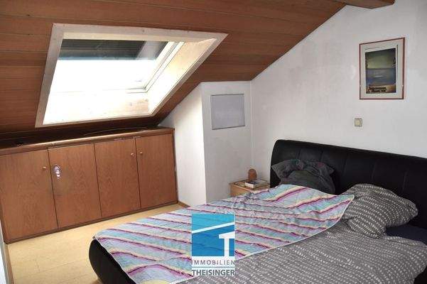 Schlafzimmer mit Fenster u. Einbaumöbel im Dachgeschoss