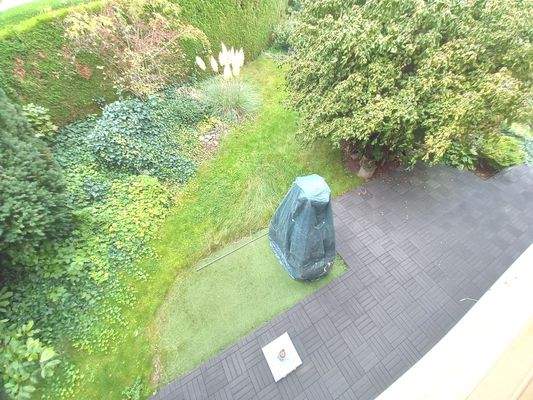 Blick vom Balkon auf Terrasse und Garten