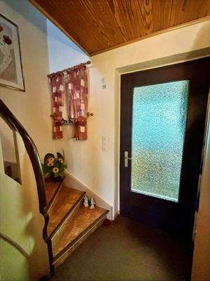 Eingangstür und Blick auf die Treppe ins Dachgeschoss