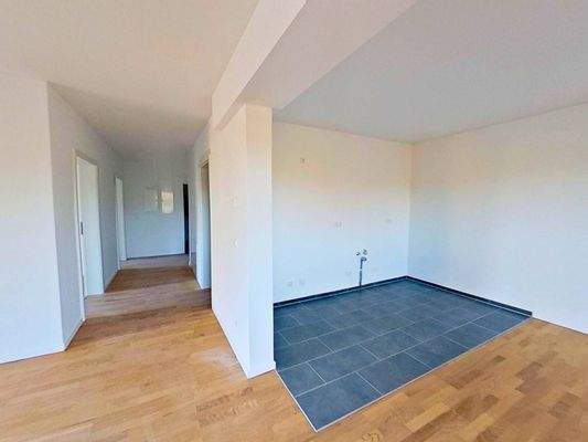 Ansicht IV: Wohn- und Esszimmer mit offenem Küchenbereich