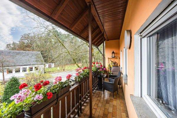 Überdachter Balkon mit Blick in den Garten