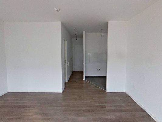 Ansicht III: Wohn- und Schlafzimmer mit offenem Küchenbereich