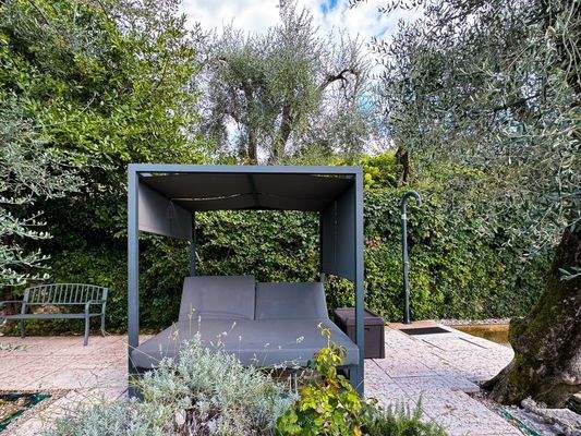 Gartenterrasse mit Liegen und Baldachin - terrazza nel giardino con lettini e baldacchino
