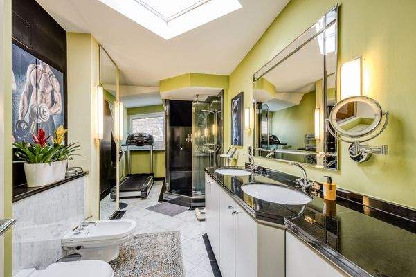 Luxuriöses Badezimmer mit Dachfenster, großem Doppelwaschplatz und integrierter Fitnessfläche