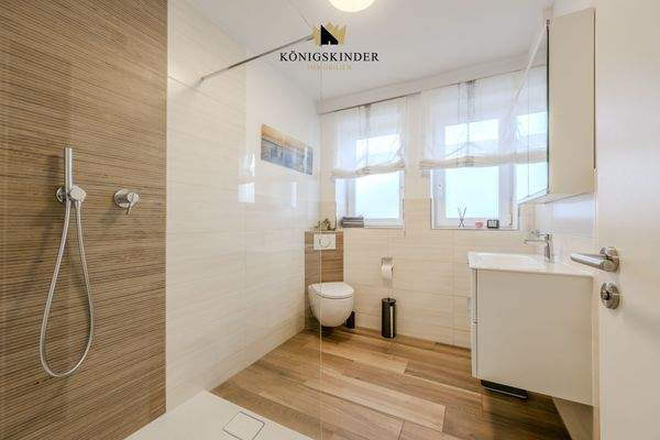 Elegantes EG-Bad mit großzügiger, bodengleicher Dusche.