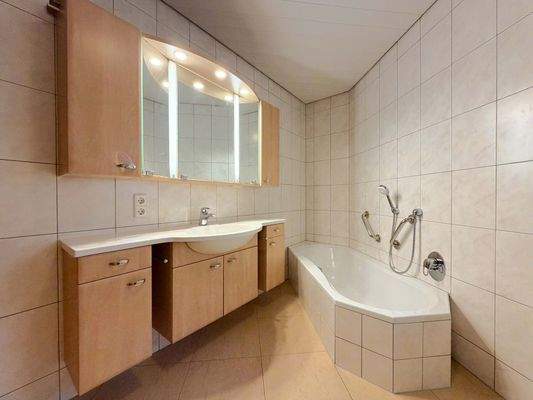 EG: Das Badezimmer mit gemütlicher Badewanne und schönem Stauraum