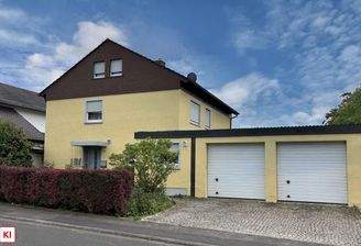 Straßenansicht mit Doppelgarage und integriertem Hauswirtschaftsraum