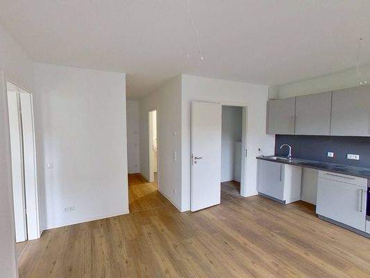 Ansicht IV: Wohn- und Esszimmer mit offenem Küchenbereich