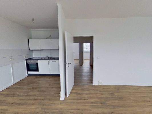 Ansicht III: Wohn- und Esszimmer mit offenem Küchenbereich