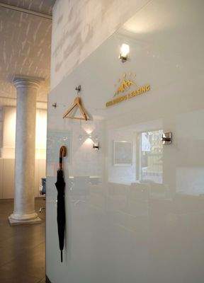 Moderne Garderobenlösung an der Glaswand mit Brand