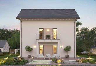 Dieses massa haus Fertighaus Einfamilienhaus im Lifestyle-Design präsentiert bei Abenddämmerung sein